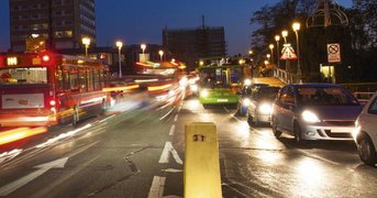 Night, busy city traffic, time-lapsed to create headlight blur.