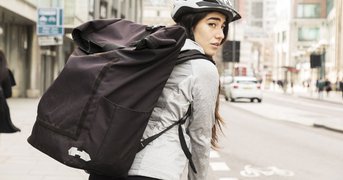 Young female cyclist looks over their shoulder.