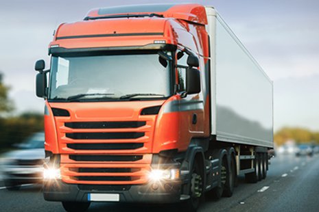 HGV driving with lights on along motorway