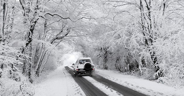 4 x 4 x vehicle driving thourgh rural snowy conditions