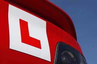 Learner plate positioned on rear of a red car