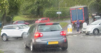 Heavy rain, day, junction traffic.